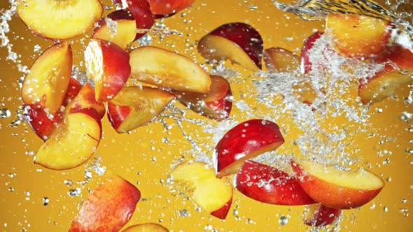 Super Slow Motion Shot of Flying Fresh Peach Slices and Water Side Splash at 1000Fps. alt