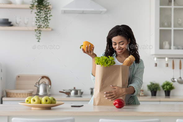Happy black lady enjoy organic healthy food. Online order, delivery from supermarket or market