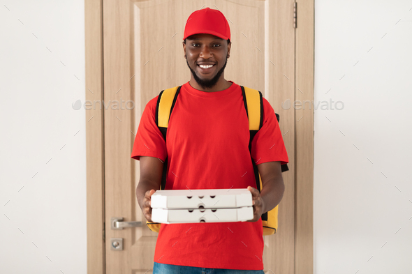 Black Deliveryman Holding Pizza Boxes And Posing At Door Stock Photo By Prostock Studio