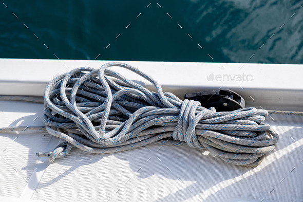 Yachting rope on the sailing boat bow, blur sea water background