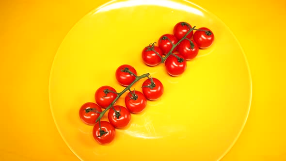 Ripe Fresh Juicy Organic Cherry Tomatoes on a Yellow Plate alt