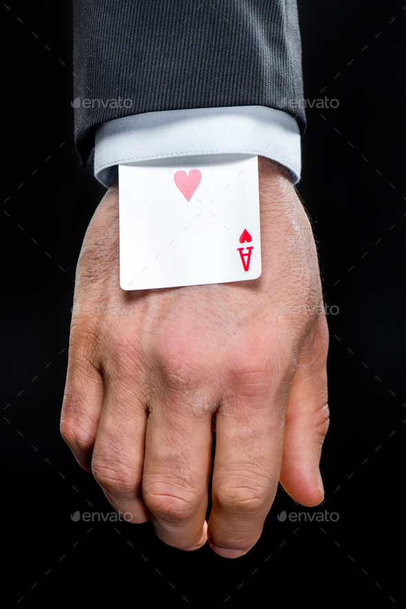 Ace of hearts playing card hidden in sleeve isolated on black