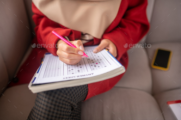 Close up of girl doing test while learning English