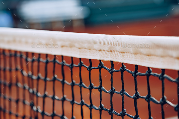 Close up of net on tennis court Stock Photo by FabrikaPhoto