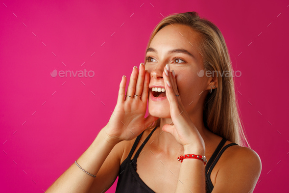 Cute blonde woman screams using her hands as tube