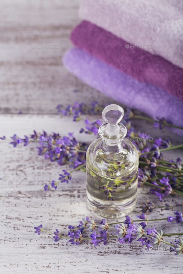 Bottle of essential oil and fresh lavender flowers Stock Photo by svittlana