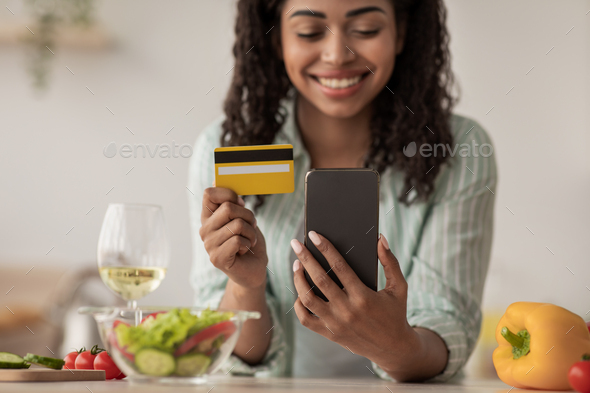 Happy buyer, store customer makes payment with money from banking at home