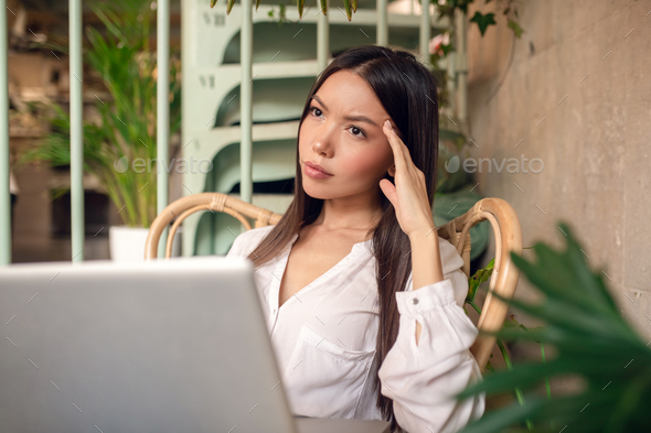 Businesswoman having headache after working for too long
