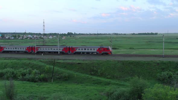 Passenger Train Passing Through the Fields in the Countryside alt