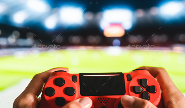Young man having fun playing online soccer video games