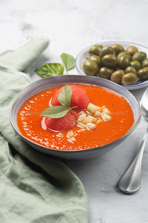 Cold traditional Spanish gazpacho with olives and garlic