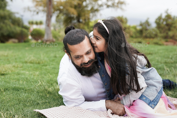 Indian father enjoy pic nic with daughter at city park - Stock Photo - Images
