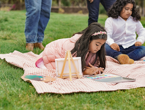 Happy indian family enjoy day at city park - Family, parents and children love - Stock Photo - Images
