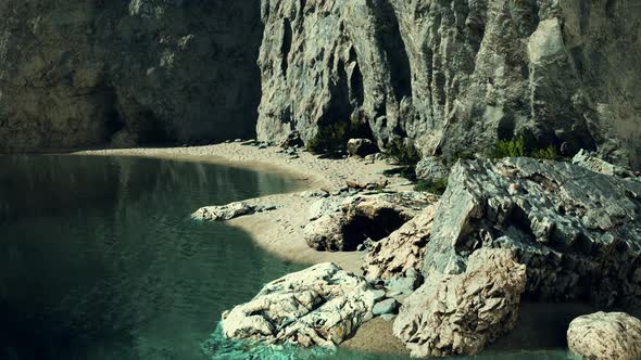 Beach Coast of the Norwegian Sea with Mountains and Cliffs on Sunny Day alt