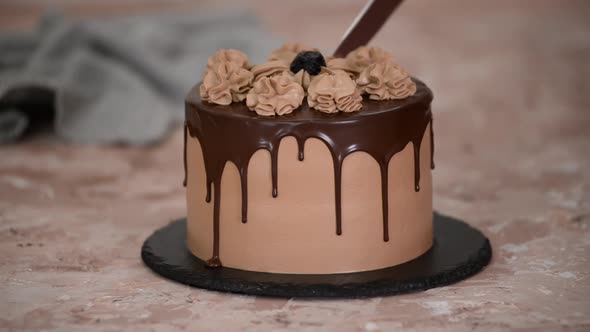 Pastry Chef Cuts Chocolate Cake with Knife