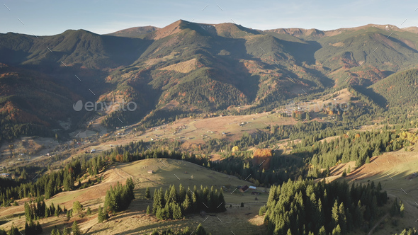 Countryside village at mountain valley aerial. Nobody nature landscape. Cottages at rural road - Stock Photo - Images