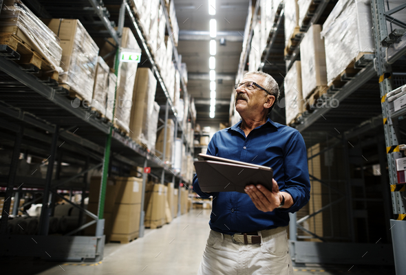 A caucasian warehouse manager checking stock inventory - Stock Photo - Images