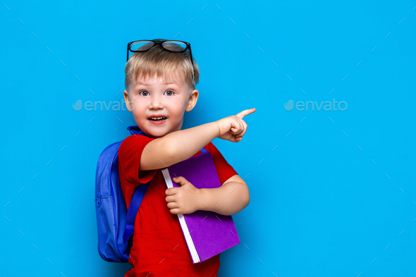 Back to school First grade junior lifestyle. Small boy in red t-shirt. Close up studio photo