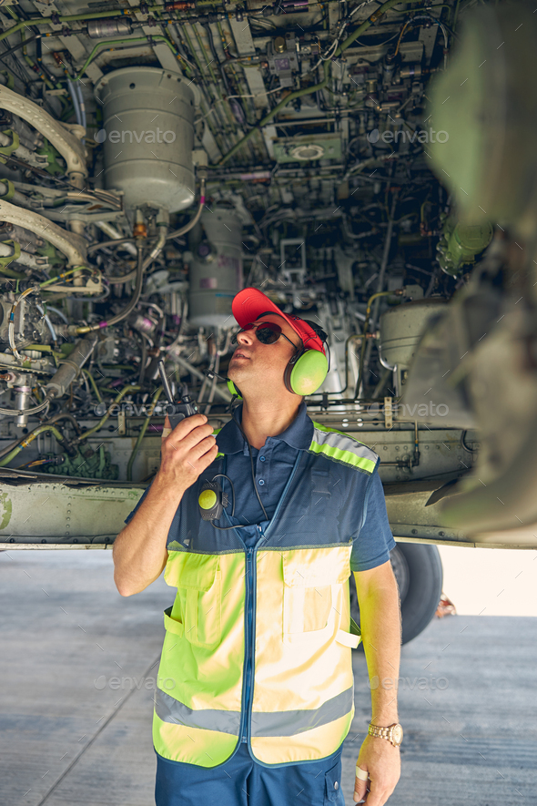 Qualified aviation mechanic inspecting the airplane bottom