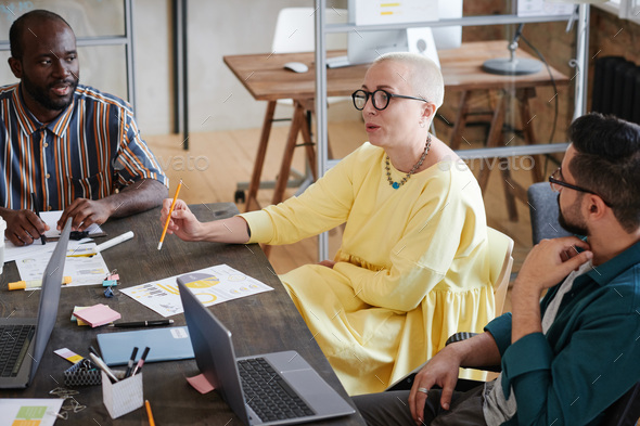 Business leader talking to her employees - Stock Photo - Images