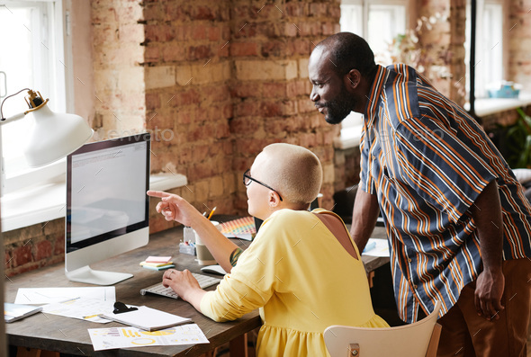 Business couple working on computer - Stock Photo - Images
