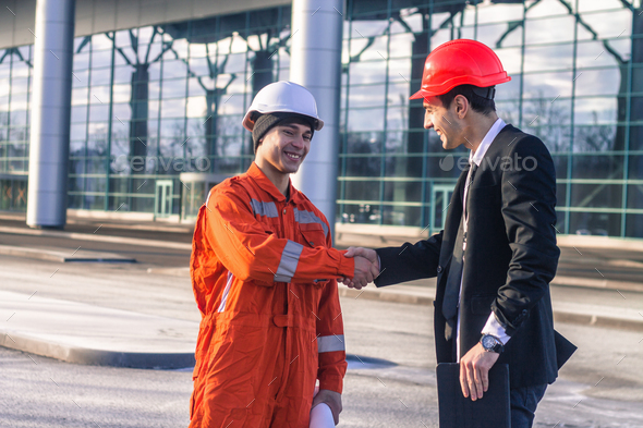 young boss and worker in conversation shaking hands