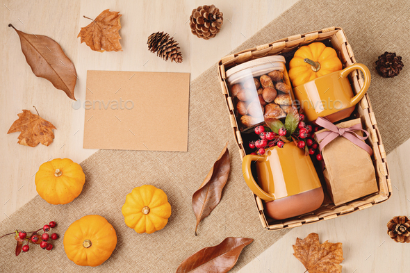Preparing care package for thanksgiving, seasonal gift box with cup, tea or coffee package and