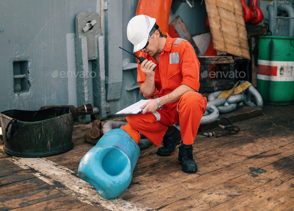 chief officer on deck of ship or vessel with checklist