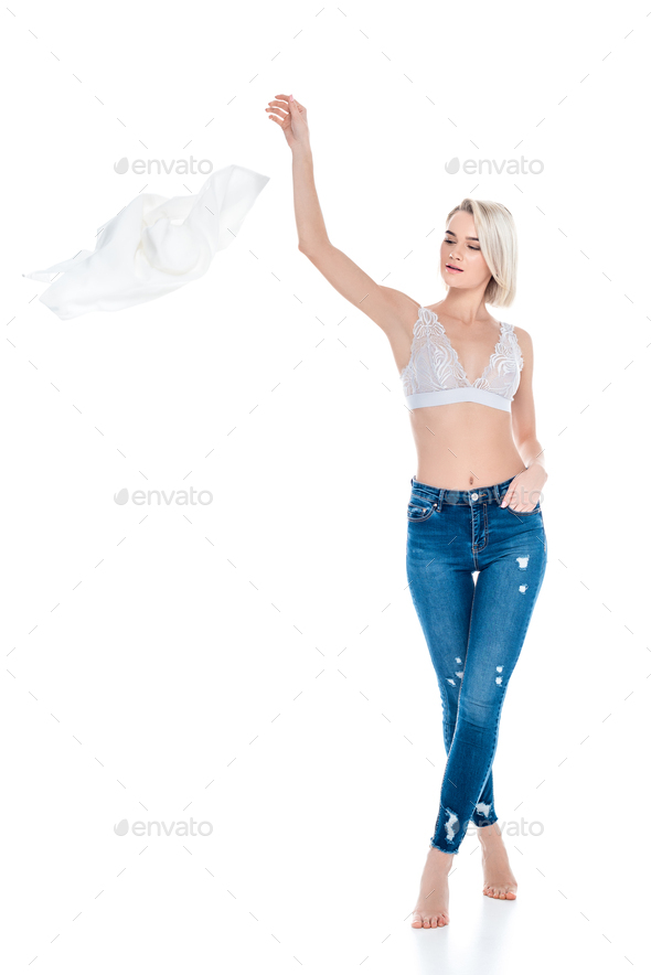 seductive woman in sexy underwear looking at man sitting on sofa and taking  off clothing isolated on Stock Photo by LightFieldStudios