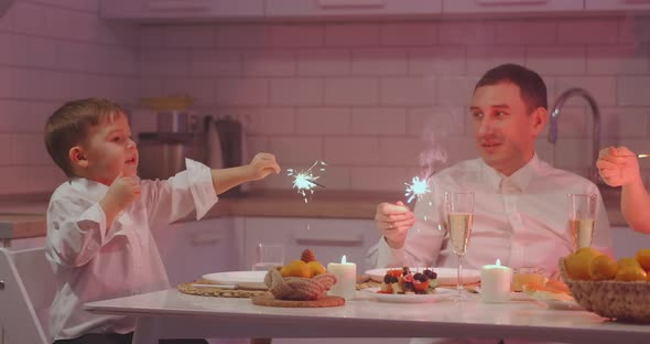 Cheerful Family with Different Ages Holding Sparkles Celebrating Christmas alt