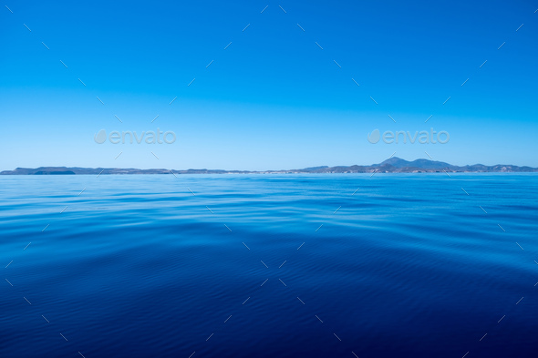 Greece. Aegean sea. Blue sky, land and calm sea water background Stock  Photo by rawf8