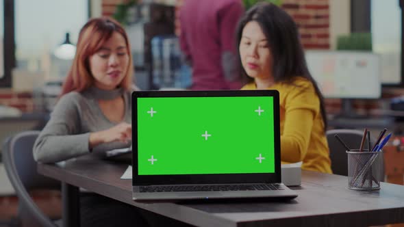Laptop Computer with Blank Green Screen on Business Office Desk alt