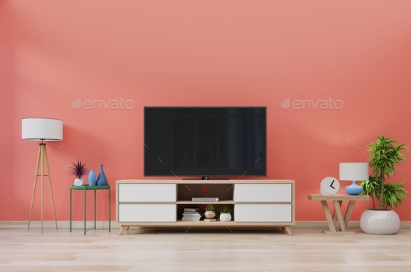 TV in modern room with decoration on living coral color wall background.  Stock Photo by vanitjan