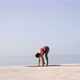 Yoga Training by Adult Woman on Empty Dock With Sea and Sky on Background - VideoHive Item for Sale