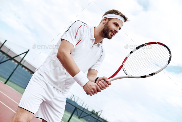 Professional tennis player is doing a kick tennis on a tennis court - Stock Photo - Images
