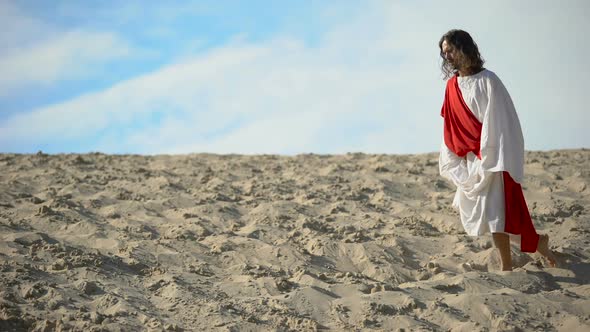 Righteous Man Kneeling in Desert, Praying to God With Raised Hands, Confession alt