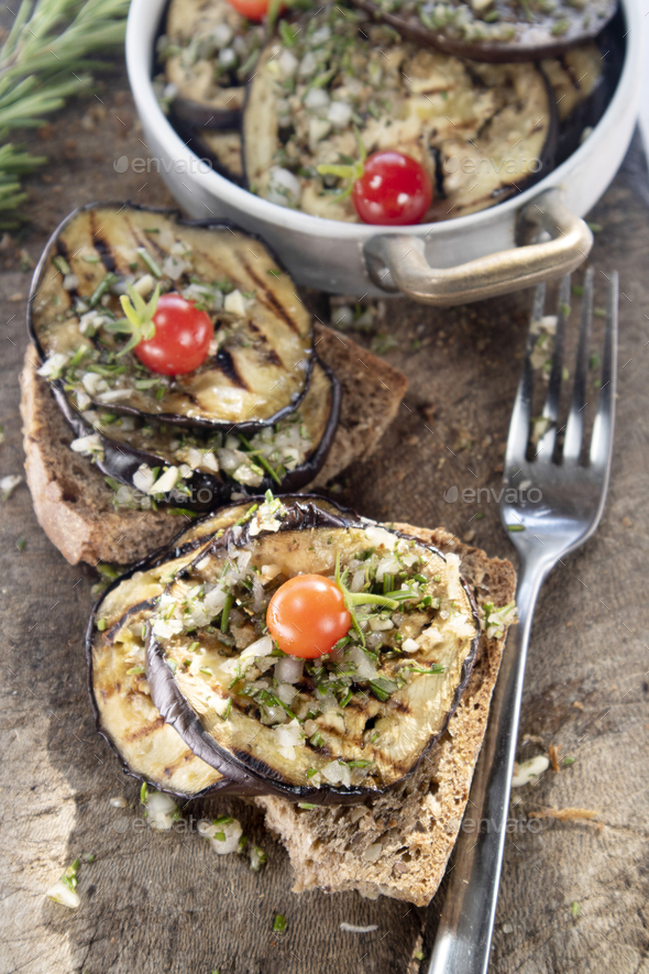 Bruschetta with grilled aubergine and Pachino tomatoes Stock Photo by ...