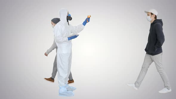 Man in Hazmat Suit Checking Temperature and Stopping Woman on Gradient Background alt