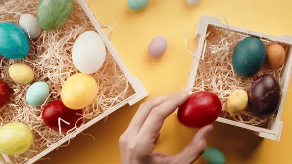 Boxes of Colorful Easter Eggs with Yellow Background alt