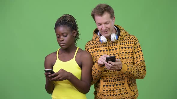 Young Multi-ethnic Couple Using Phone Together alt