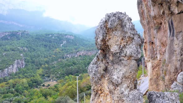 Rocky Cliff on the Background of Green Mountain Valley alt