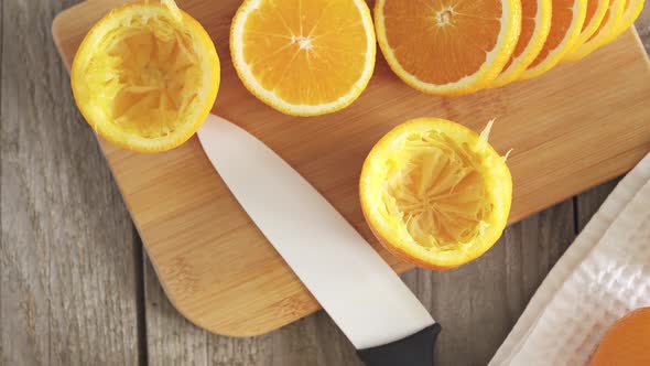 Ripe Juicy Citrus Fruits On A White Kitchen Towel.Manual Juicer. Bamboo Board With Orange Slices alt