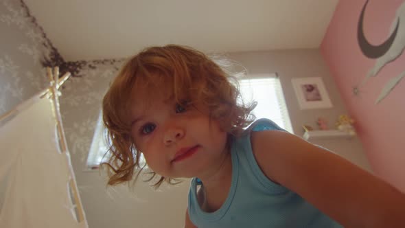 Close-up of Little Girl Playing in Her Room alt