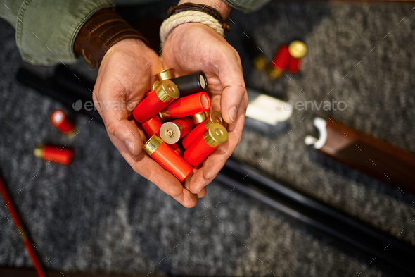 Male hunter hands holds cartridges in gun store - Stock Photo - Images