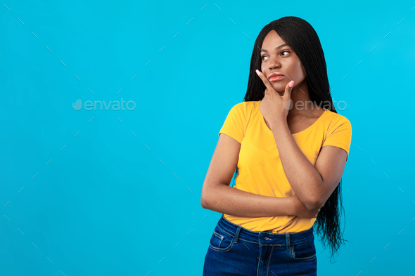 African American Lady Thinking Standing Near Blank Space, Blue Background