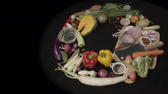 Top View Fresh Fish Fillets Vegetable And Spices On Black Table. With Copy Space alt