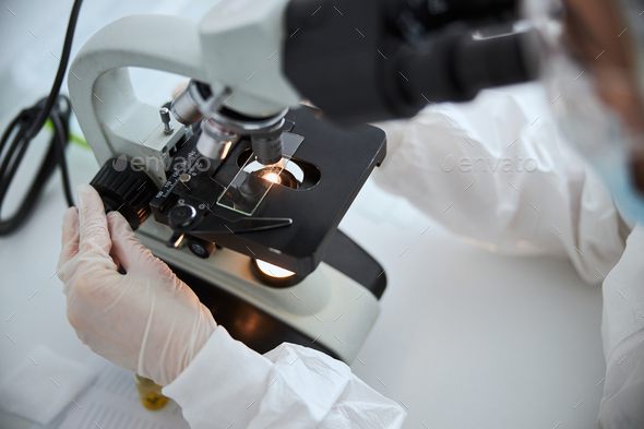 Microbiologist observing a microscopic specimen under the microscope