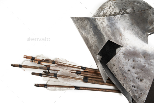 Medieval iron helmet and arrows isolated on white