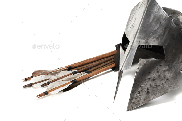 Ancient helmet and wooden arrows isolated on white