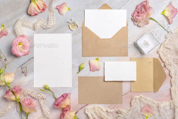 Wedding stationery set with envelope laying on a marble table